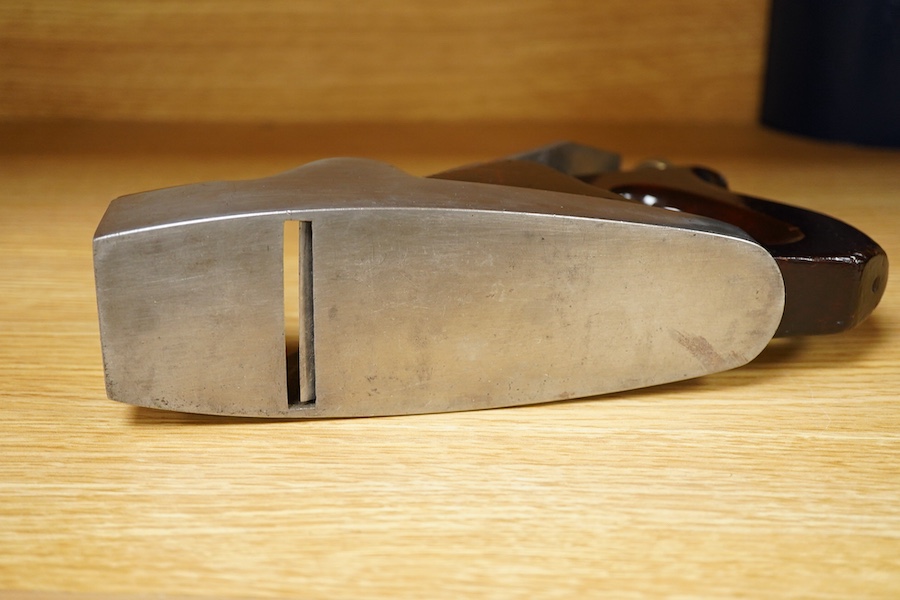 A Norris adjustable smoothing plane, stamped with Norris, London to the brass lever cap, with replacement iron, owner’s name lightly stamped to both sides of the handle, the front infill with a screw inserted down throug